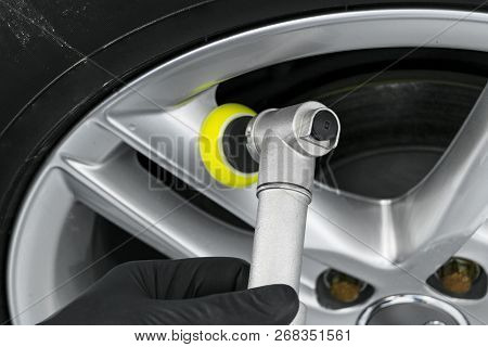 Car Polish Wax Worker Hands Polishing Wheel. Buffing And Polishing Car Disk. Car Detailing. Man Hold
