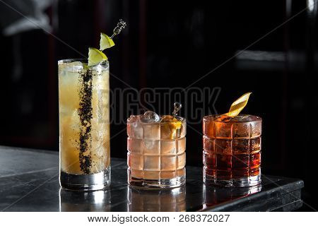 Three Special Cocktails Cocktail On A Bar Desk. Black Background