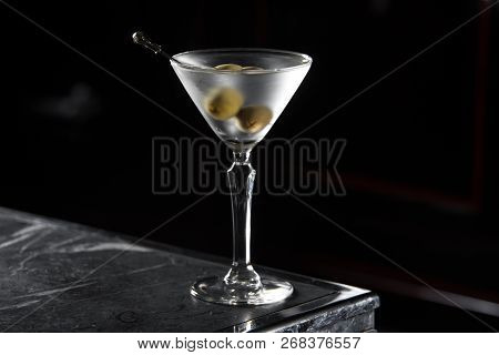 Dry Martini Cocktail On A Bar Desk. Black Background