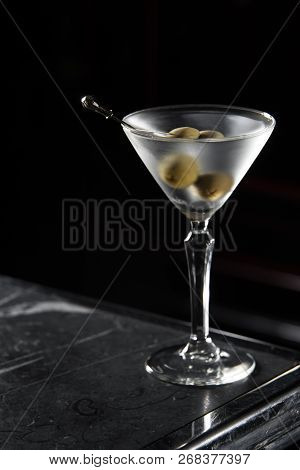 Dry Martini Cocktail On A Bar Desk. Black Background