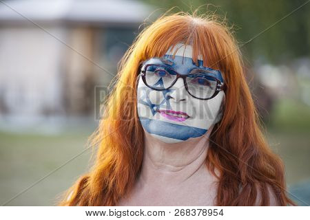 Portrait Of Old Woman With Painted Flag Of Israel In The Street