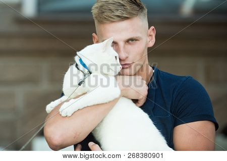 He Is More Than Just A Pet. Happy Cat Owner With Muscular Look. Cat Relaxes In Arms Of His Owner. Ha