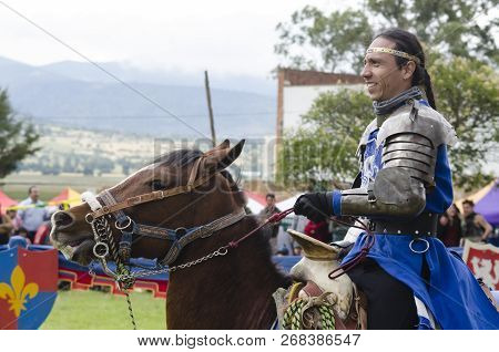 Tlaxcala, Mexico- September 29, 2018: Knight With Blue Clothes And Armor Riding A Horse And Smiling 