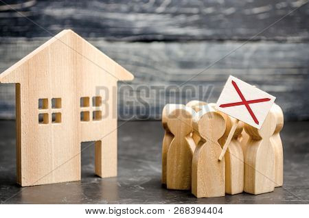A Crowd Of People Protests Against The Rising Prices And Cost Of Services Near A Wooden House. Strik