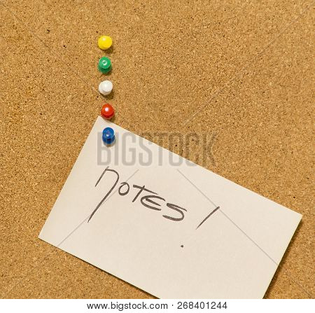 Notes On The Cork Board- Adhesive Note With Blue Pin On Cork Board