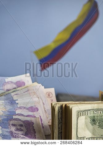 Savings In Search Of The Dream Of Traveling To Colombia - Colombian Banknotes And Dollars With The C