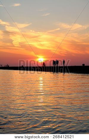 Silhouettes Of People On The Pier At Sunset In Kincardine, Ontario