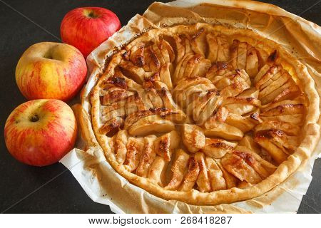Homemade Apple Tart With Greaseproof Paper And Three Red Apples