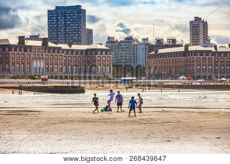 Mar Del Plata, Argentina - 26 Octubre, 2018: Children playing football on the shores of the Atlantic Ocean