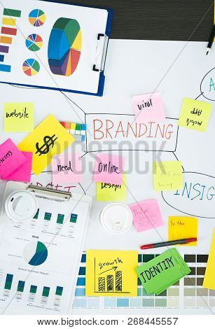 Top View Of Creative Designer Brainstorming Ducument On Wood Table In Meeting Room