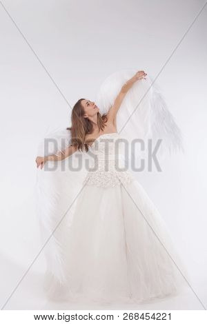 Girl In White Dress With Angel Wings On White Background. Angel-woman