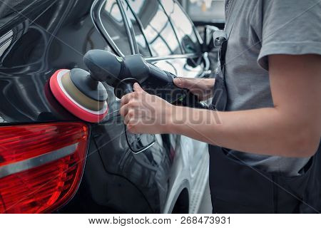 Polishing Machine On The Surface Of The Black Car Close-up