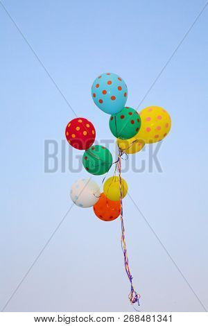 Helium Balloons. Colorful helium balloons. Floating away in the blue sky. Birthday Balloons. Party Time.