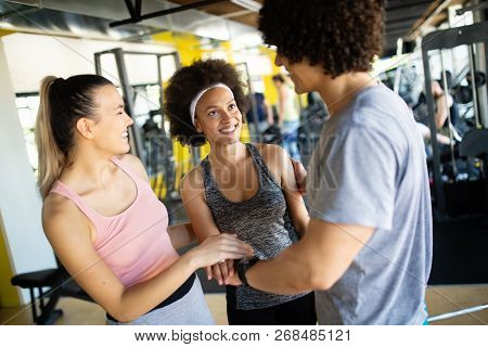 Happy Gorup Of Healthy People Training In Gym