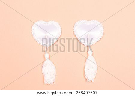 Tassel Burlesque Pasties On Nude Background. Flat-lay, Top View. Copy Space For Your Text.