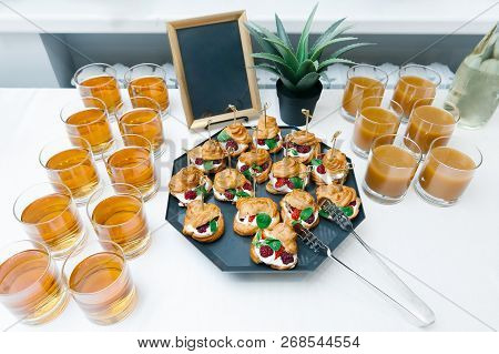 Sweet Catering With Berry Cackes And Juice At White Table
