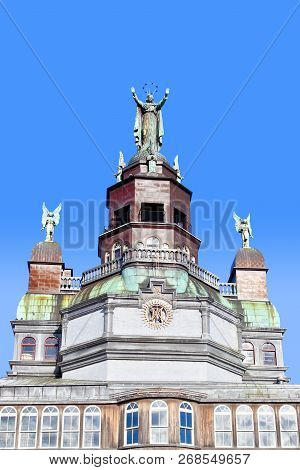 Magnificent Facade Of The Historic Notre-dame-de-bon-secours That Features A Statue Of Mary With Her