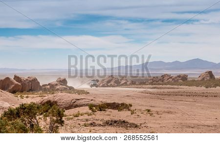 SUV riding in sunshine mountanious Bolivia desert