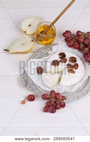 Camembert With Honey, Pear And Grapes And Walnuts