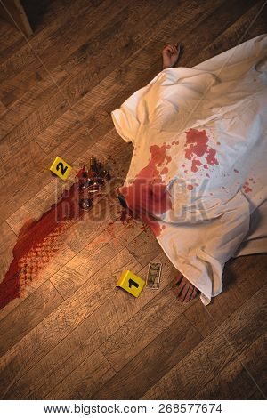 Top View Of Dead Body Covered With White Sheet At Crime Scene