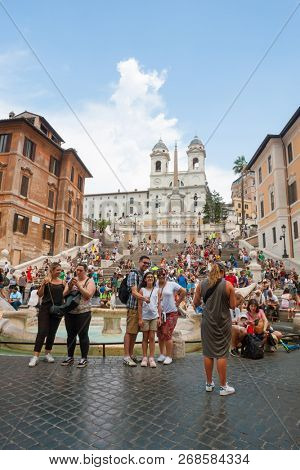 ROME - AUGUST 3: The Spanish Steps, with tourists, seen from Piazza di Spagna on August 3, 2018, Rome.The Spanish Steps are the widest staircase in Europe.