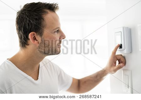 A Man Set The Thermostat At House