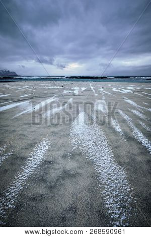 Rocky coast of fjord of Norwegian sea in winter. Skagsanden beach, Lofoten islands, Norway
