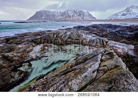 Rocky coast of fjord of Norwegian sea in winter. Lofoten islands, Norway