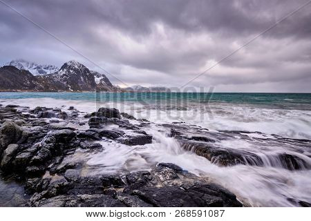 Rocky coast of fjord of Norwegian sea in winter. Vareid, Lofoten islands, Norway