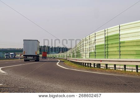 The Road Is Protected Against Noise Emission By Noise-absorbing Barrier (also Called A Soundwall, No