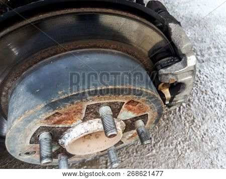 Hub With Brake Disc And Brake Shoes. The Arch Of The Car With The Removed Wheel