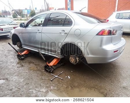 Krasnodar, Russia - March 15, 2017: The Car Is At The Tire Shop. Under The Jack The Car In Car-care 