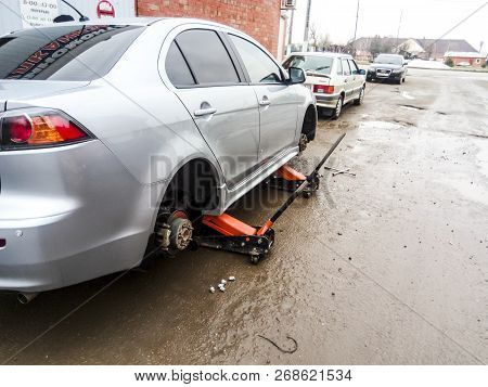 Krasnodar, Russia - March 15, 2017: The Car Is At The Tire Shop. Under The Jack The Car In Car-care 