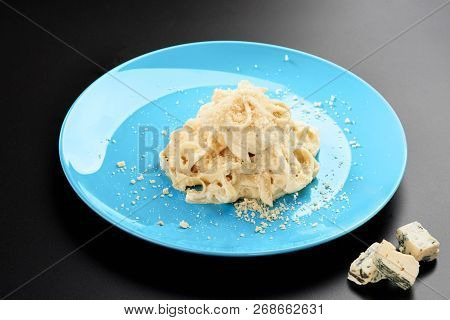 Plate Of Italian Penne Pasta With A Formaggio Creamy Savory Sauce And Basil Served In A Blue Dish Bl