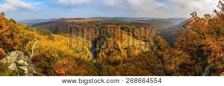 Panoramic View Of Beautiful Autumnal Landscape With River Valley, Colorful Forests, Blue Sky And Clo