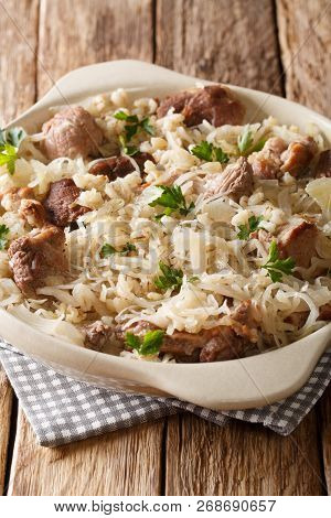 Delicious Traditional Estonian Mulgikapsas  Stewed Pork With Sauerkraut And Barley Close-up In A Pan