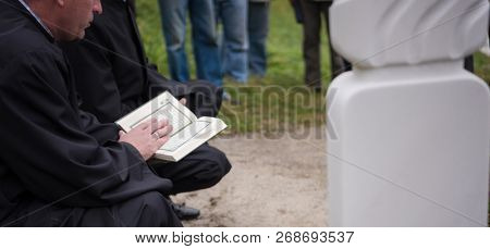 quran holy book reading by imam  on islamic funeral with white thumb stones graweyard background