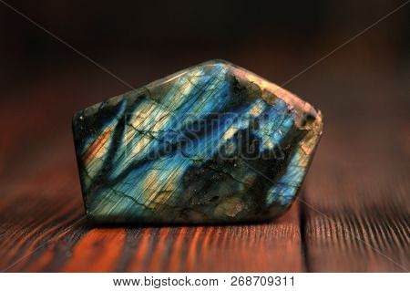 Polished Blue Labradorite On A Wooden Background