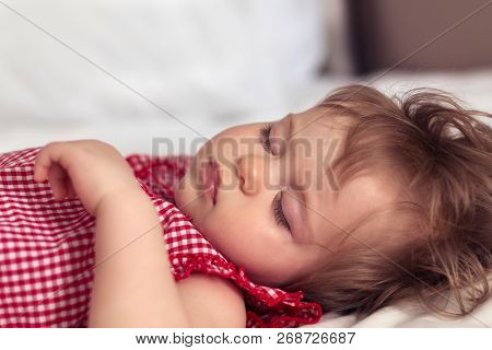 Close Up Portrait Of A Beautiful Nine Month Old Baby Girl Sleeping On Blurred Background. Sleeping C