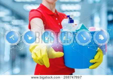 A Cleaning Woman In Rubber Gloves Is Keeping A Bucket Fulfilled With Chemicals And Touching A Screen