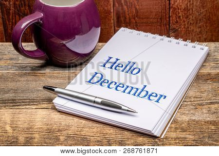Hello December  - text in a sketchbook with a mug og hot tea or coffee