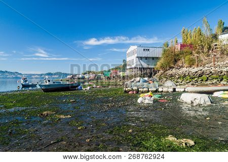 Castro, Chile - March 23, 2015: Fishing Boats And Palafitos Stilt Houses During Low Tide In Castro, 