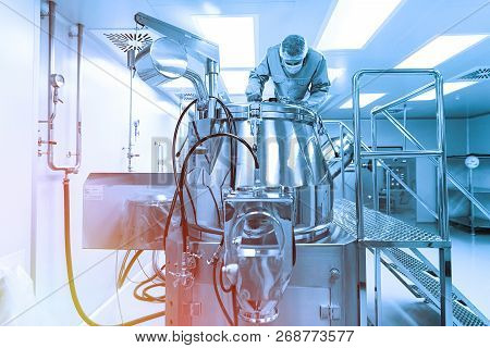 Scientist Look In Steel Tank In Laboratory. Blue Tone. Blue Tint