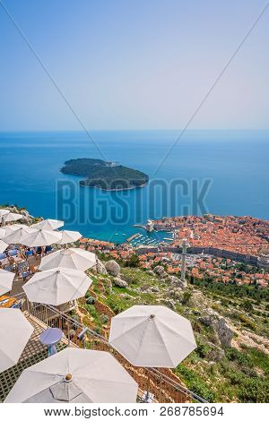 Umbrellas Providing Shadow For Restaurant Customers On Top Of A Srd Hill With The View Of The Old Ci