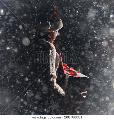 Christmas Gift Concept. Man In Santa Hat Bring Gift For You. Attractive Man Hold Box.  Christmas And