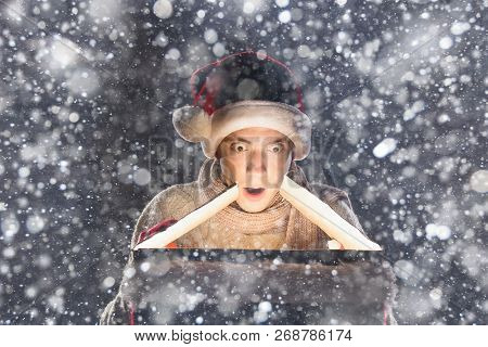Christmas Gift Concept. Man In Santa Hat Bring Gift For You. Attractive Man Hold Box.  Christmas And