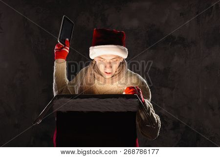 Christmas Gift Concept. Man In Santa Hat Bring Gift For You. Attractive Man Hold Box.  Christmas And