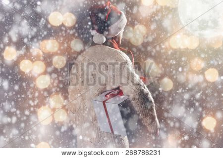 Christmas Gift Concept. Man In Santa Hat Bring Gift For You. Attractive Man Hold Box.  Christmas And