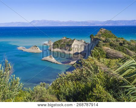 Aerial View On Of White Rock Steep Cliff Volcanic Bay Of Cape Drastis And Peroulades Area With Tropi