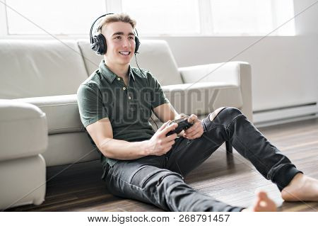 Young Attractive Man Playing Video Games In The Livingroom